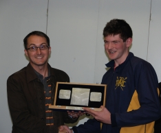 Tom Barras receiving the Silver Sculls in their wooden presentation box